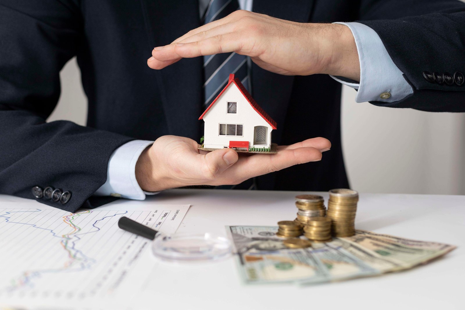 Home Loan, showing house in hand of banker