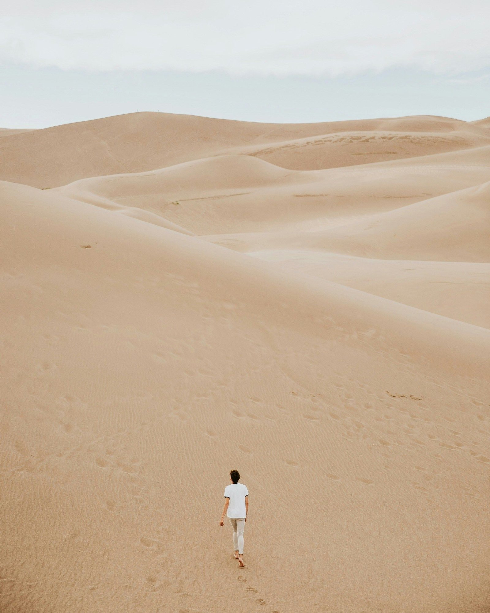 a man walking in desert
