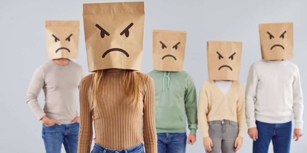 People wearing shopping bags, showing anger toward brands